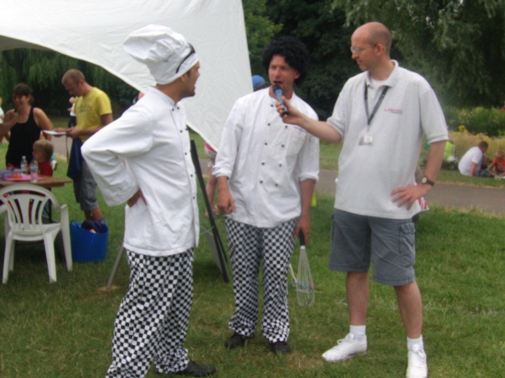 Presenter Chris Daniels gets some cooking tips from the Zooted Mad Chefs
